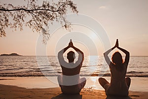 yoga for couple, healthy lifestyle and harmony in relations, silhouettes of man and woman meditatiing