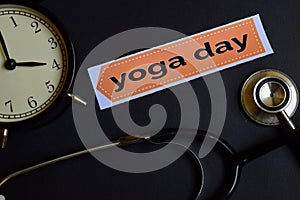 Yoga Day on the print paper with Healthcare Concept Inspiration. alarm clock, Black stethoscope.