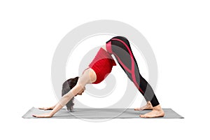 Yoga, downward facing dog pose. Fit caucasian woman in red sportswear practice Adho mukha svanasana exercise, isolated