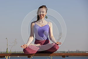 Yoga exercise - woman doing yoga pose meditation in the public park sport healthy concept