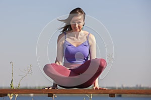 Yoga exercise - woman doing yoga pose meditation in the public park sport healthy concept