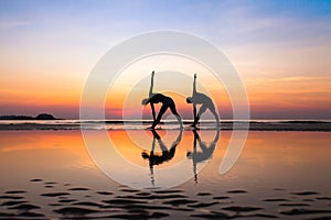 Yoga exercises, silhouettes of couple