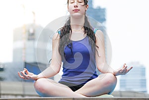 Yoga fitness lifestyle healthy woman relaxation doing a meditation. Yoga meditating outdoor with zen on sitting position. Young