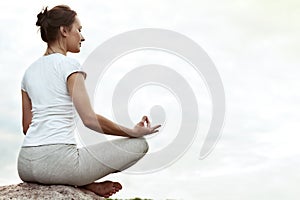 Yoga girl making a dzen or zen and smilling.