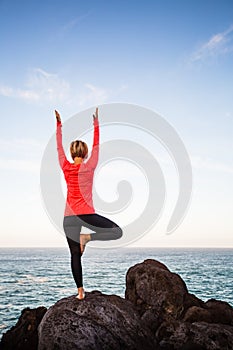 Yoga girl meditating in vrksasana tree pose