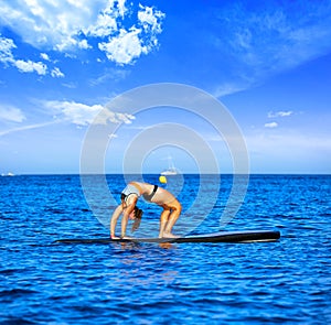 Yoga girl over SUP Stand up Surf board