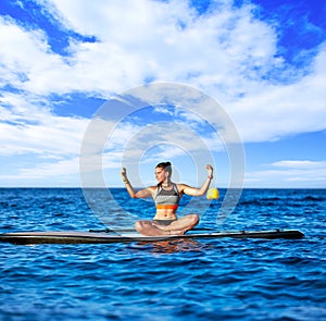 Yoga girl over SUP Stand up Surf board