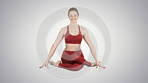 Yoga girl practicing nadi shodhana pranayama or Breathingin in gomukhasana asana or cow head pose on gradient background