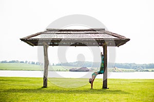 Yoga girl training outdoors on nature background.