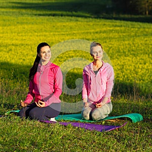 Yoga Girls on the background field of yellow flowers.