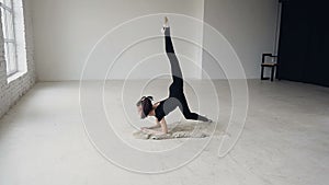 Yoga - gymnastic girl make exercise training in sport school. Flexibility exercise training. Young fit teenage girl