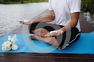 Yoga hand meditation exercise near pond