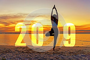 Yoga Happy new year card 2019. Silhouette woman practicing yoga standing as part of Number 2019