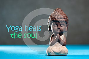 Yoga heals the soul - motivational inscription on picture with baby buddha