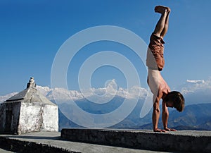 Yoga in Himalays. Handstand.