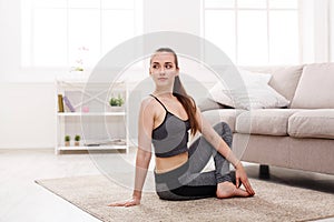 Yoga at home. Woman stretching seated spinal twist pose