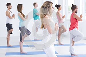 Yoga instructor standing with other practitioners