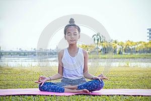 Yoga kid Meditation Practice , the girl`s practice yaga on the day i