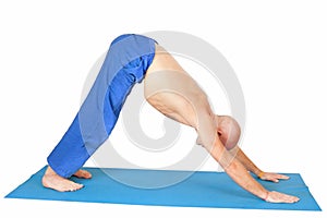 Yoga. Man in Adho Mukha Svanasana position photo