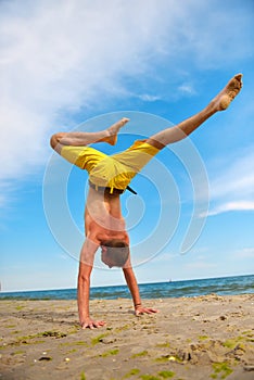 Yoga man standing on hands