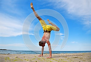 Yoga man standing on hands