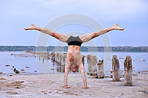 Yoga man standing on hands