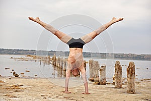 Yoga man standing on hands