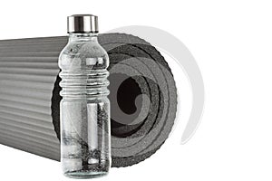 Yoga mat with bottle of water isolated on white background. Concept healthy lifestyle