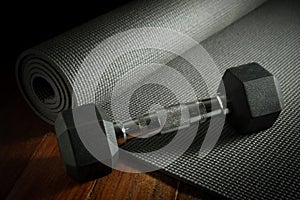 Yoga mat with metal dumbbell.