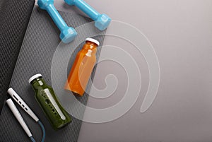 Yoga mat, protein and detox bottles, dumbbells and jumping rope