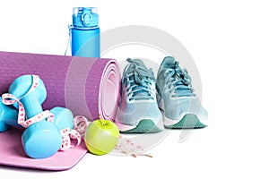 Yoga mat, sneakers, dumbbells and bottle of water isolated on white background.