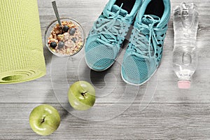 Yoga mat with sport shoes and healthy food