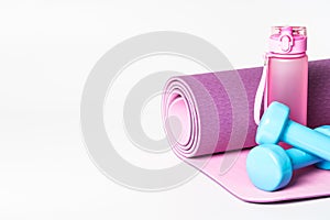 Yoga mat and water bottle isolated on white background.