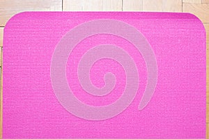 yoga mat on wooden floor