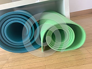 Yoga mats, rolled and stored in shelf