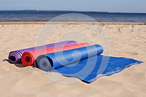 Yoga mats thrown on the beach - preparing for the lesson.