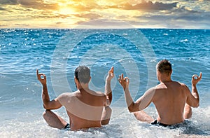 Yoga meditation on beach, enjoying the sunset