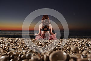 Yoga and meditation on calm beach at sunrise
