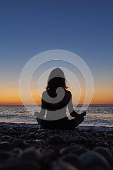 Yoga and meditation on calm beach at sunrise