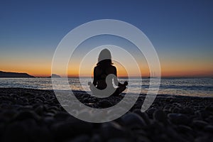 Yoga and meditation on calm beach at sunrise