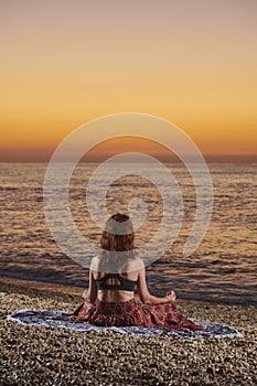 Yoga and meditation on calm beach at sunrise