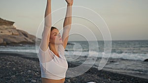 Yoga and meditation concept. Attractive young woman do meditation on sunset.