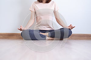 Yoga and meditation lifestyles. close up view of young beautiful woman practicing yoga namaste pose in the living room at home