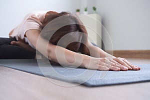 Yoga and meditation lifestyles. close up view of young beautiful woman practicing yoga namaste pose in the living room at home