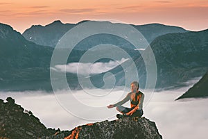 Yoga meditation in mountains man traveler relaxing alone