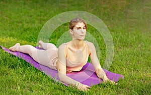 Yoga meditation in nature. Woman meditate in sunny park.