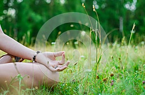 Yoga meditation in park. woman`s hand to meditate