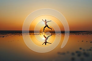 Yoga meditation with reflection of a person at the beach during sunset