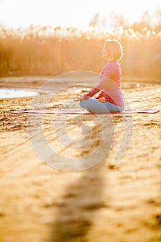 Yoga meditation, woman on sunset