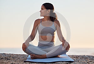 Yoga, meditation or zen exercise black woman relax on yoga mat at beach, sea or ocean for motivation, wellness or